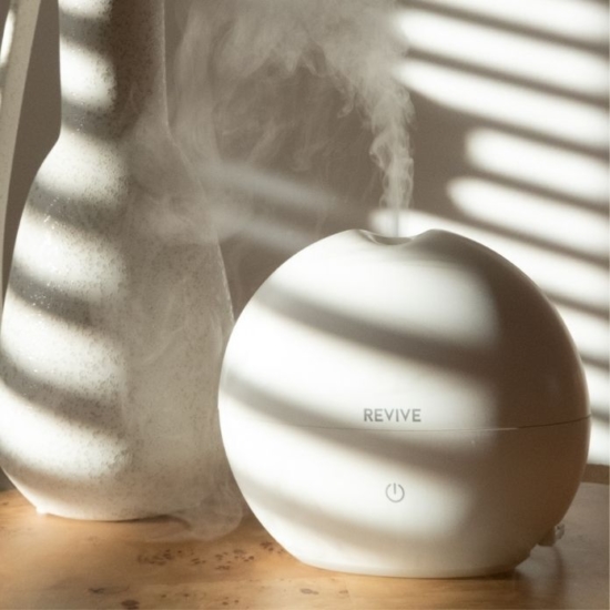 High Capacity Aroma Diffuser Lasts for Up to 7-8 Hours with Automatic Shut-Off for Home & Office Safety.
Add 5 drops of any REVIVE Essential Oil or Blend and get 8 hours of aromatherapy.
Whisper quiet.  Diffuse from your nightstand at night or in your office.
Ionizer produces “happy feeling” negative ions that help lift your mood, relieve stress and strengthen your immune system.
Perfect for home & office.  Fills bedroom, bathroom, living room, kitchen, office with diffused Essential Oils and Easy to Clean!
200mL Capacity | 300+ sq ft coverage | 2 Year Warranty
100% BPA Free.  Diffuse with Light Off or Light On.
DC 24V; 12W power adapter provided.
165mm x 150 mm (6.5in x 6in)
Instruction Manual
