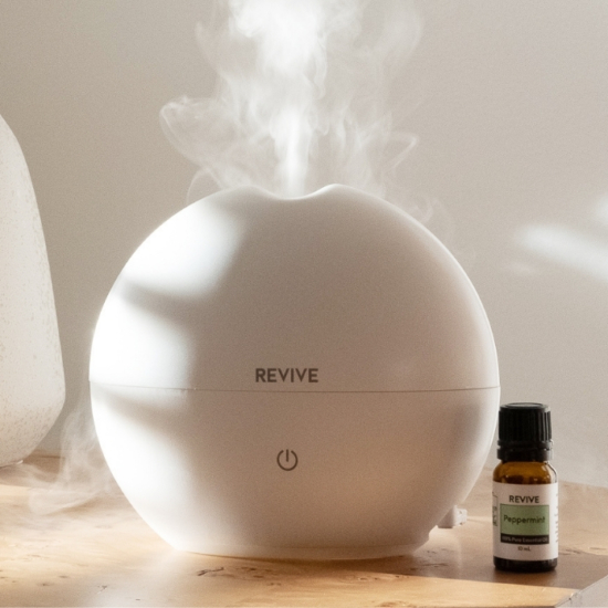 High Capacity Aroma Diffuser Lasts for Up to 7-8 Hours with Automatic Shut-Off for Home & Office Safety.
Add 5 drops of any REVIVE Essential Oil or Blend and get 8 hours of aromatherapy.
Whisper quiet.  Diffuse from your nightstand at night or in your office.
Ionizer produces “happy feeling” negative ions that help lift your mood, relieve stress and strengthen your immune system.
Perfect for home & office.  Fills bedroom, bathroom, living room, kitchen, office with diffused Essential Oils and Easy to Clean!
200mL Capacity | 300+ sq ft coverage | 2 Year Warranty
100% BPA Free.  Diffuse with Light Off or Light On.
DC 24V; 12W power adapter provided.
165mm x 150 mm (6.5in x 6in)
Instruction Manual