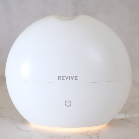 High Capacity Aroma Diffuser Lasts for Up to 7-8 Hours with Automatic Shut-Off for Home & Office Safety.
Add 5 drops of any REVIVE Essential Oil or Blend and get 8 hours of aromatherapy.
Whisper quiet.  Diffuse from your nightstand at night or in your office.
Ionizer produces “happy feeling” negative ions that help lift your mood, relieve stress and strengthen your immune system.
Perfect for home & office.  Fills bedroom, bathroom, living room, kitchen, office with diffused Essential Oils and Easy to Clean!
200mL Capacity | 300+ sq ft coverage | 2 Year Warranty
100% BPA Free.  Diffuse with Light Off or Light On.
DC 24V; 12W power adapter provided.
165mm x 150 mm (6.5in x 6in)
Instruction Manual